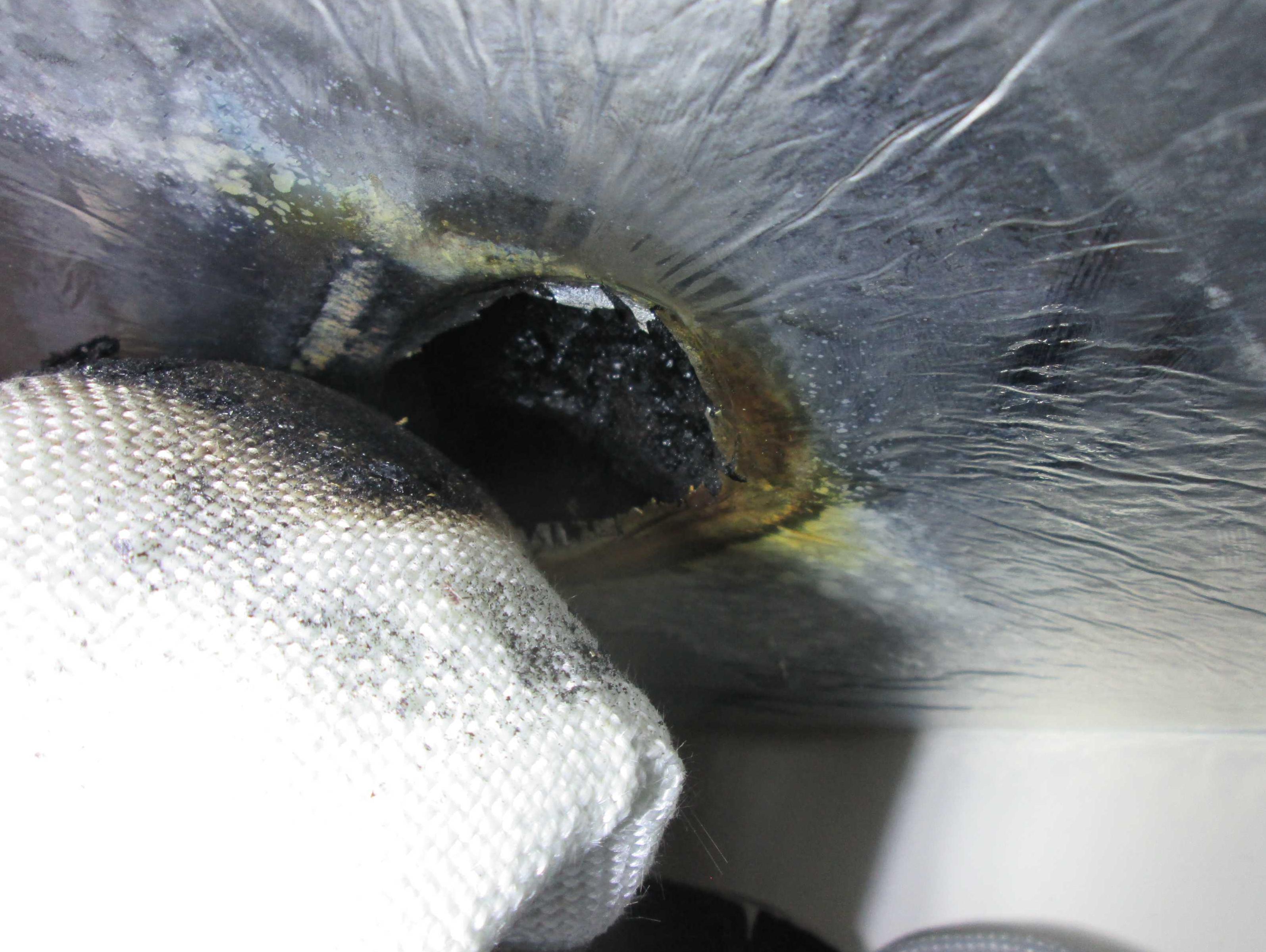 Scorched insulation next to lagged heater exhaust pipe